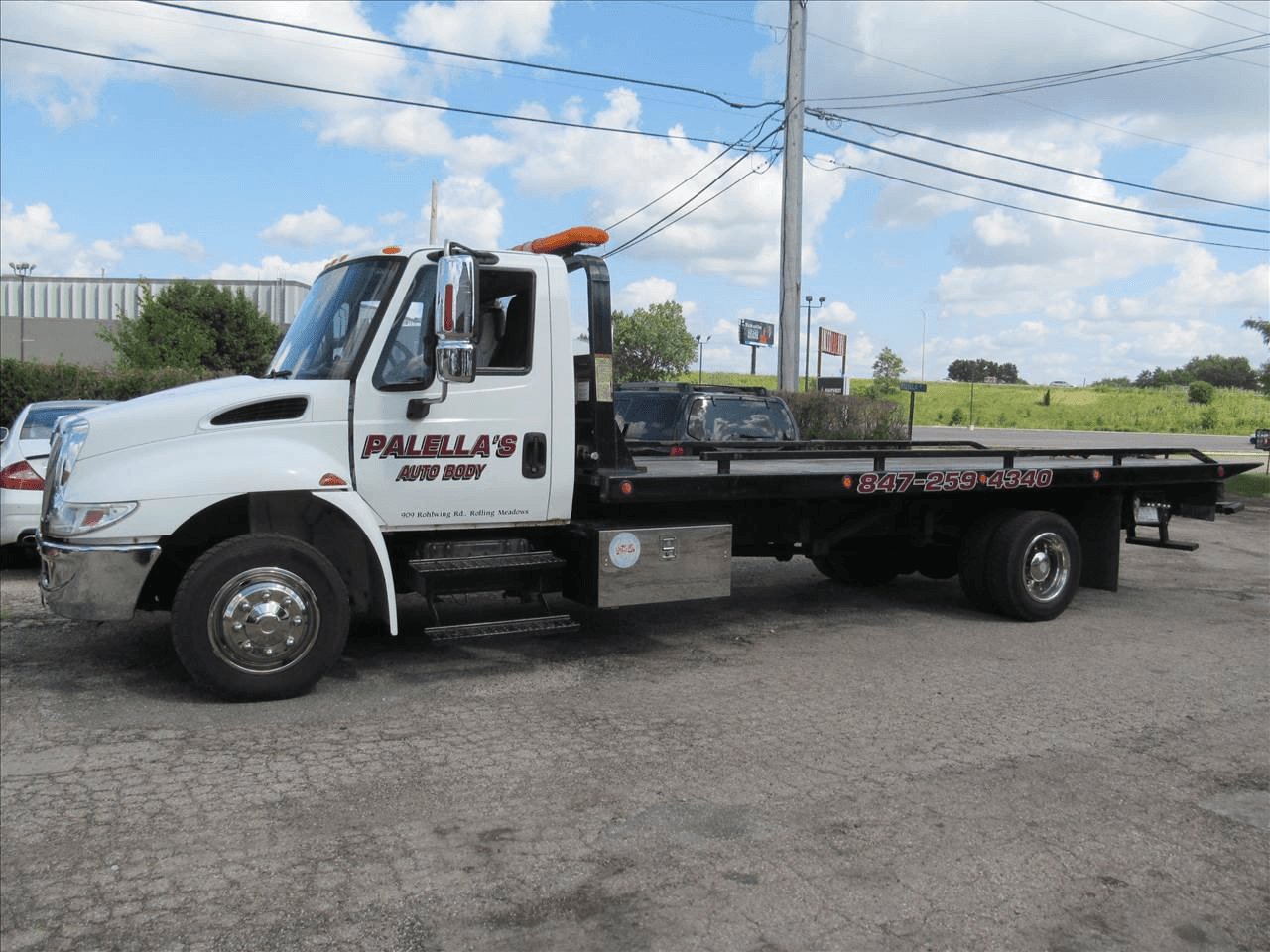 Palella's Auto Body service truck branded with the shop name, Rolling Meadows address, and phone number